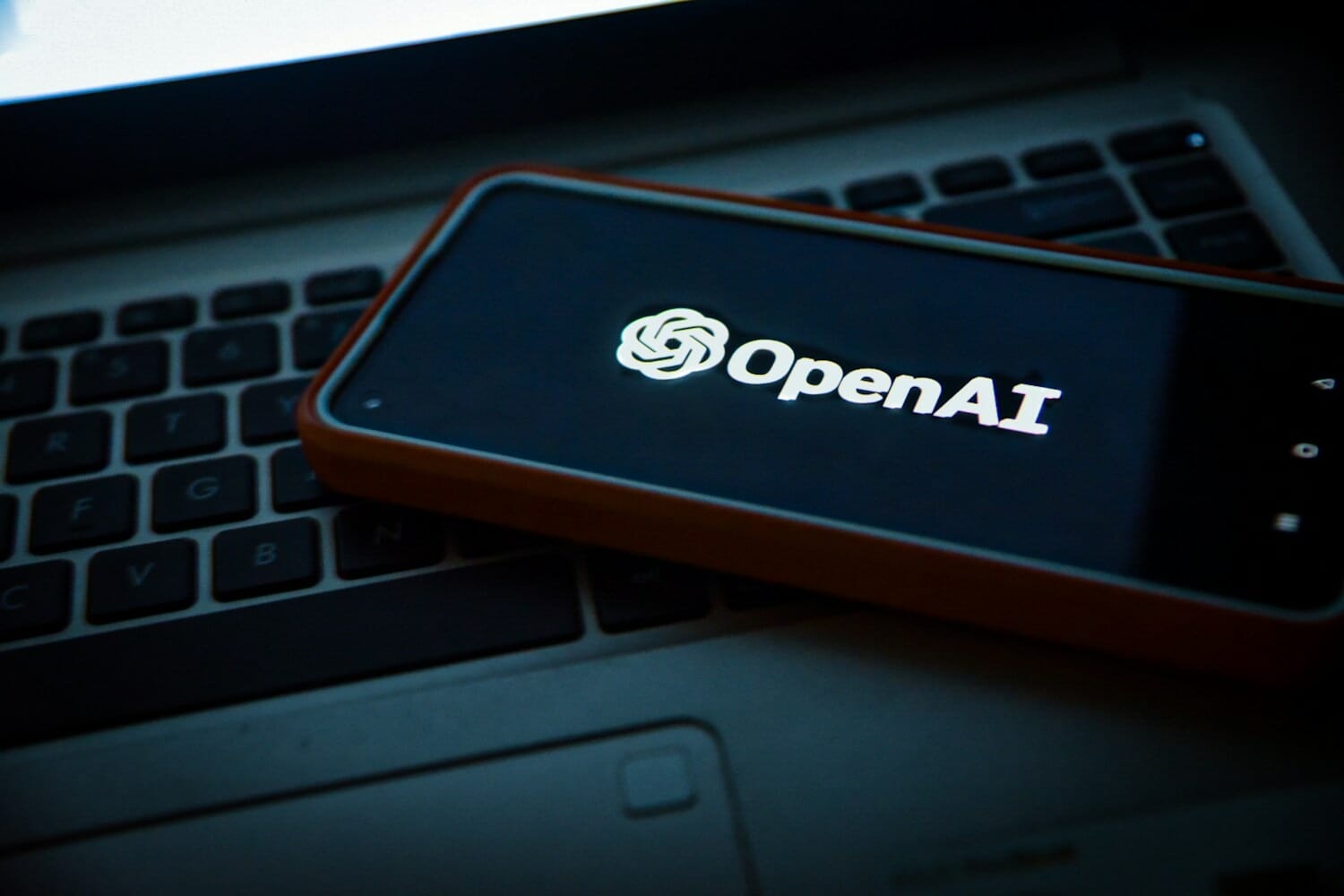 OpenAI logo on a phone screen - Sora app shutdown announcement