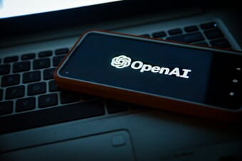 OpenAI logo on a phone screen - Sora app shutdown announcement