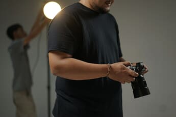 Professional photographer with DSLR camera — 58% of photographers have lost work to generative AI according to AOP survey