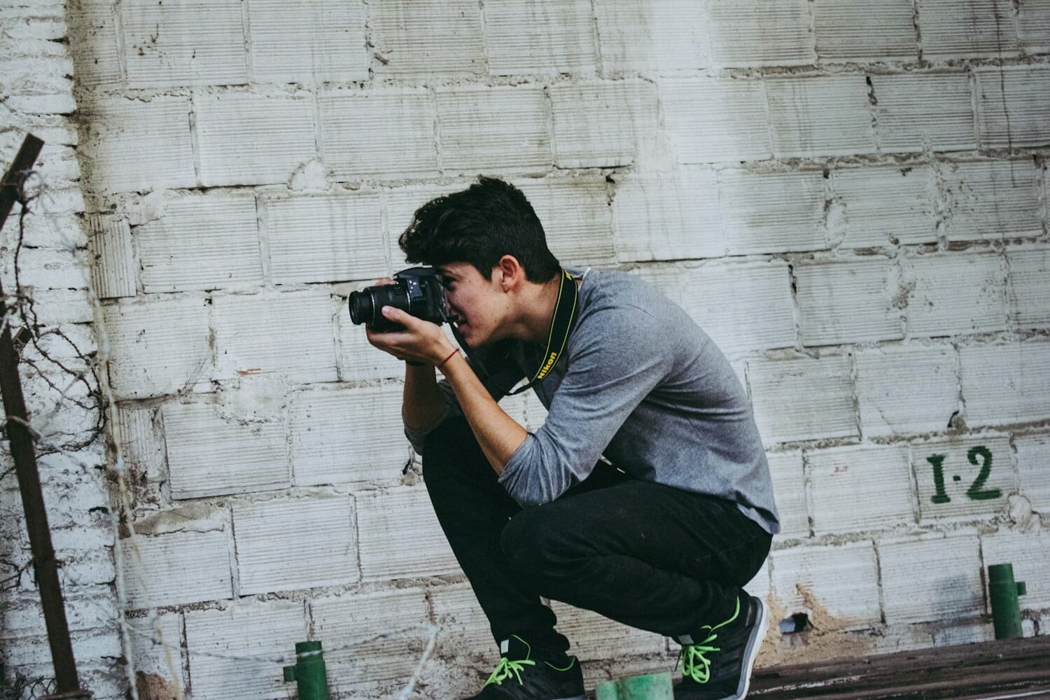 Photographer crouching low to capture a creative camera angle