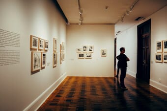 Visitor viewing photographs at a gallery exhibition — Sony World Photography Awards 2026