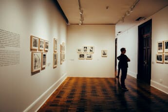 Visitor viewing photographs at a gallery exhibition — Sony World Photography Awards 2026