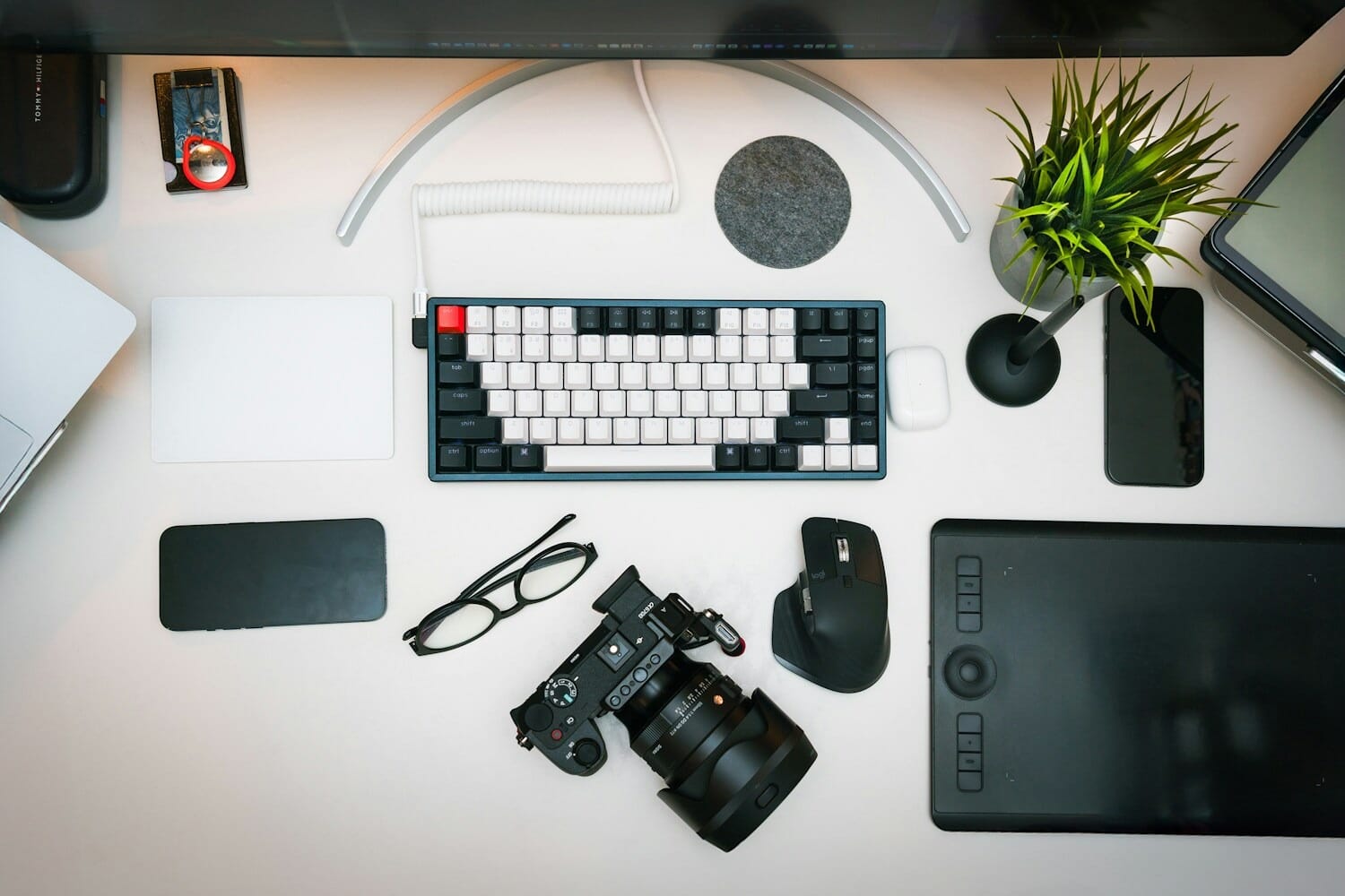 Photographer desk with camera, laptop, and editing equipment representing stock photography workflow