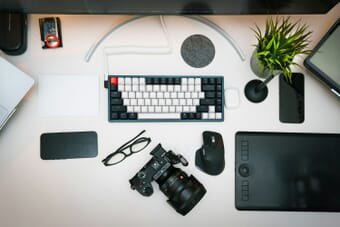 Photographer desk with camera, laptop, and editing equipment representing stock photography workflow