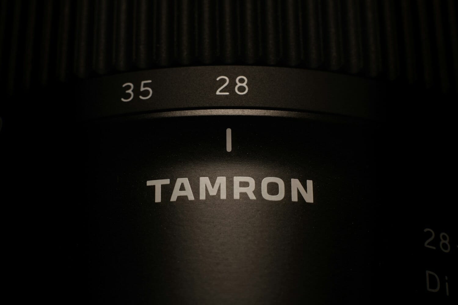 Close-up of a Tamron camera lens showing focus and zoom rings