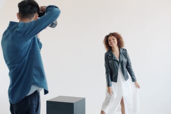 Professional photographer shooting a model in studio — one of the highest paying photography jobs