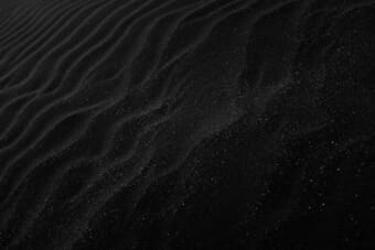 Beginner photographer taking photos in a green field — photography tips for beginners