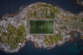 Aerial view of the Henningsvaer football pitch on a rocky island in Lofoten, Norway