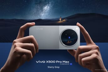 Vivo X500 Pro Max in Starry Gray held in two hands under a starry sky, showing the circular ZEISS camera module